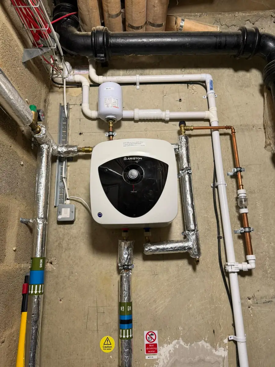 Neatly clipped and insulated heating pipework with expansion vessel installed by MK18 Plumbing Solutions